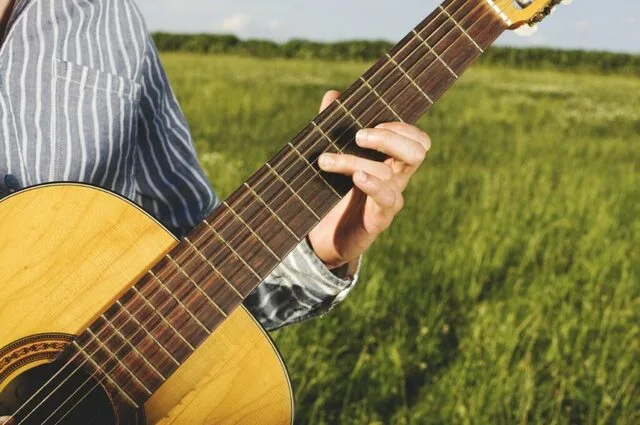 close up playing guitar