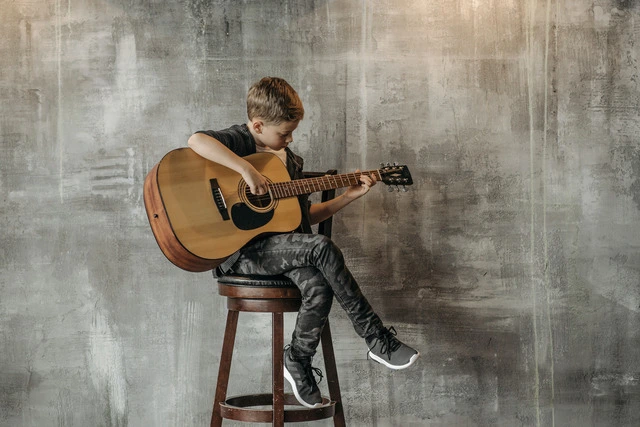 A child playing the guitar.