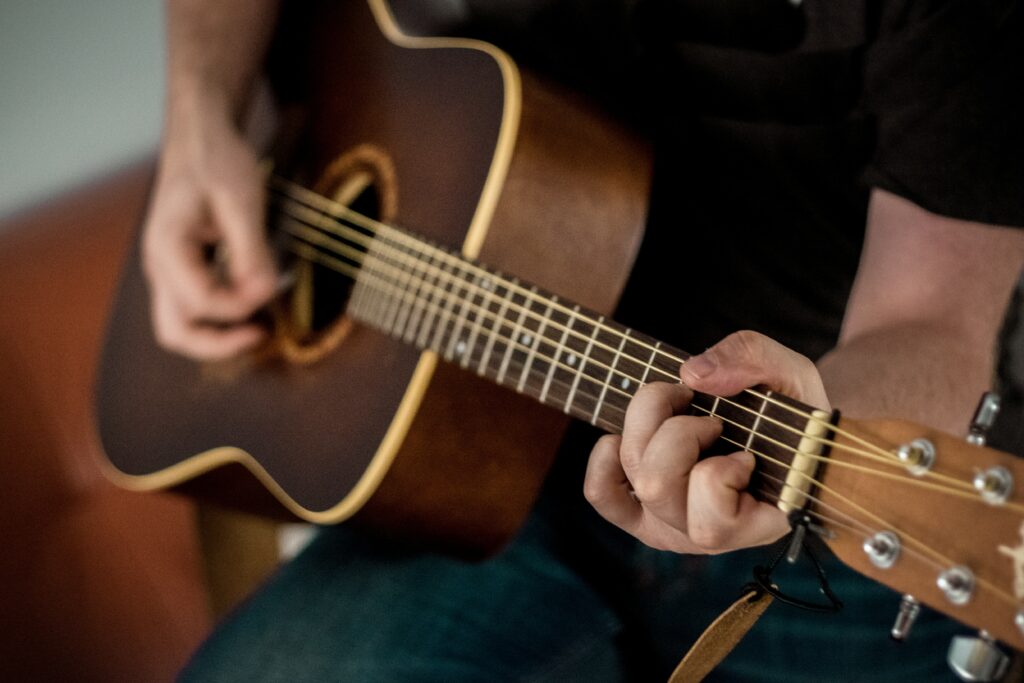 A close up of an acoustic guitar being played 