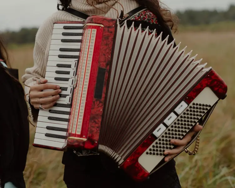 A woman playing an accordian.