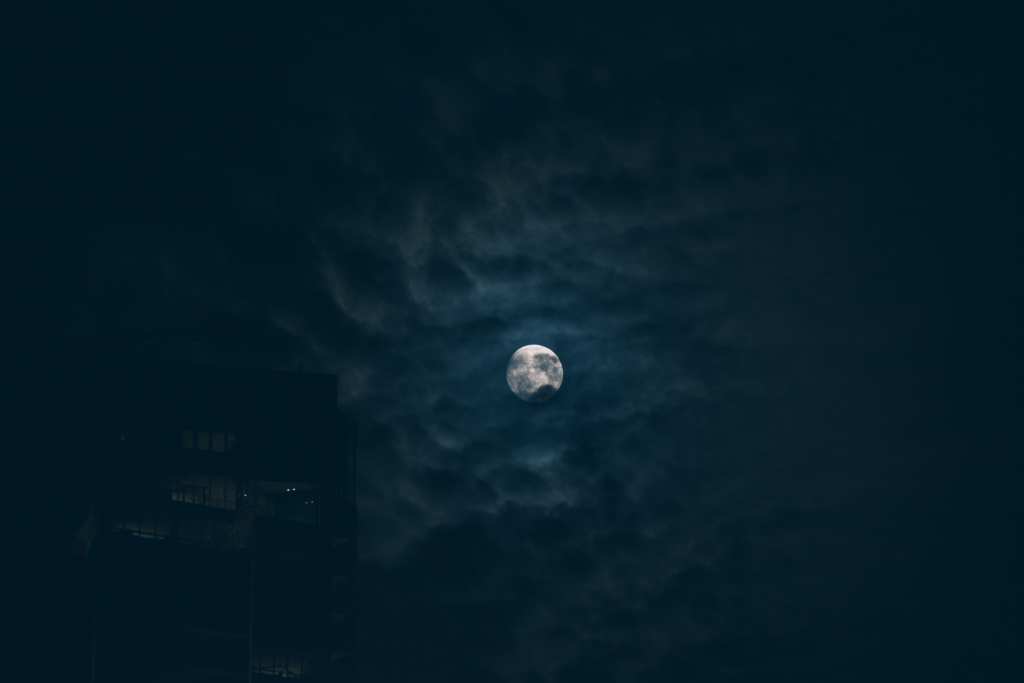 A moon in a cloudy night sky