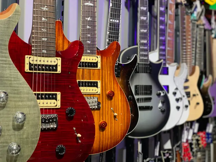 A row of electric guitars on display.