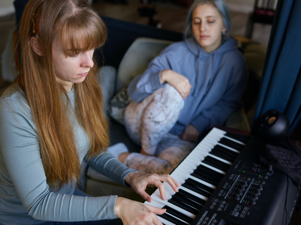 Two girls playing piano