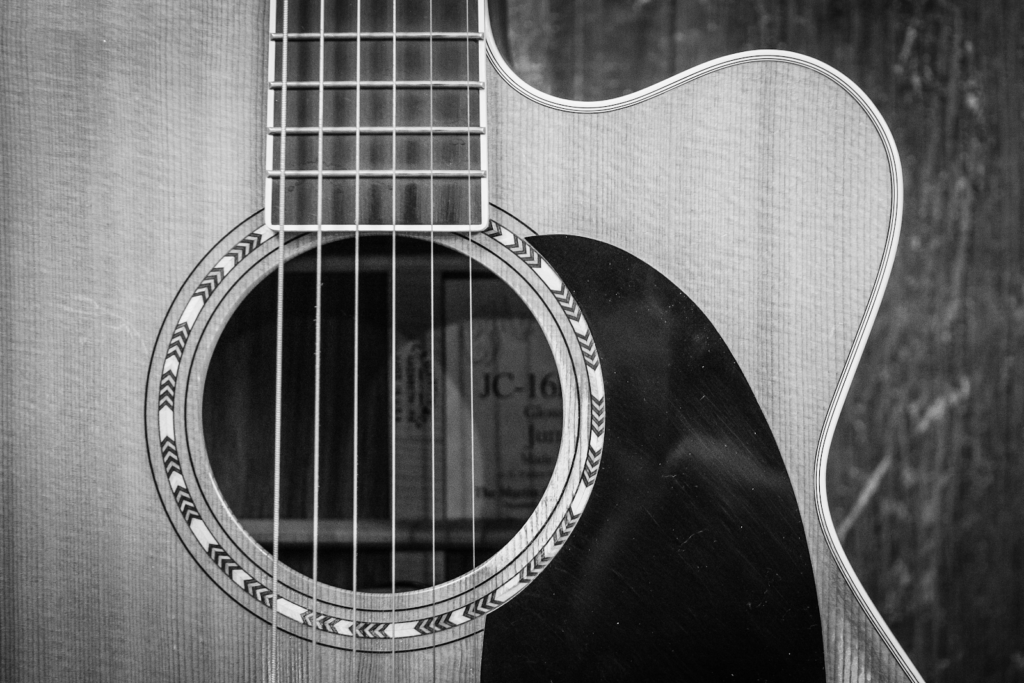 Close up of an acoustic electric guitar.