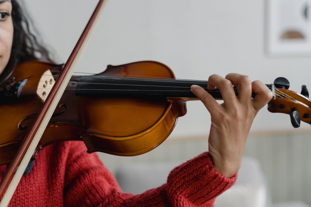 A close up of a violin being played by a woman