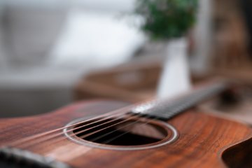 A close up of an acoustic guitars soundboard