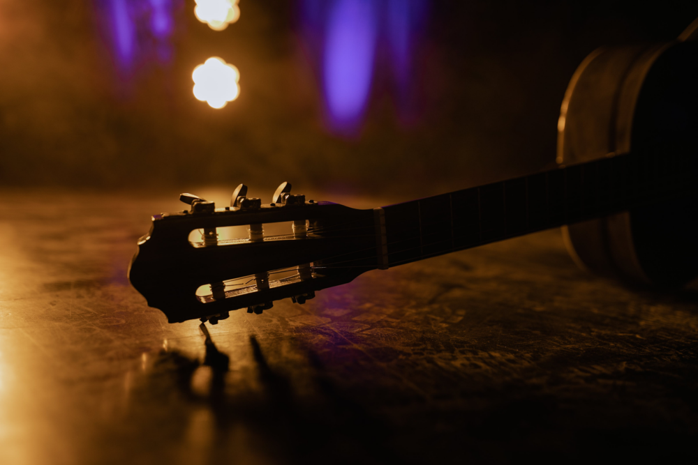 silhouette of a guitar head on a stage
