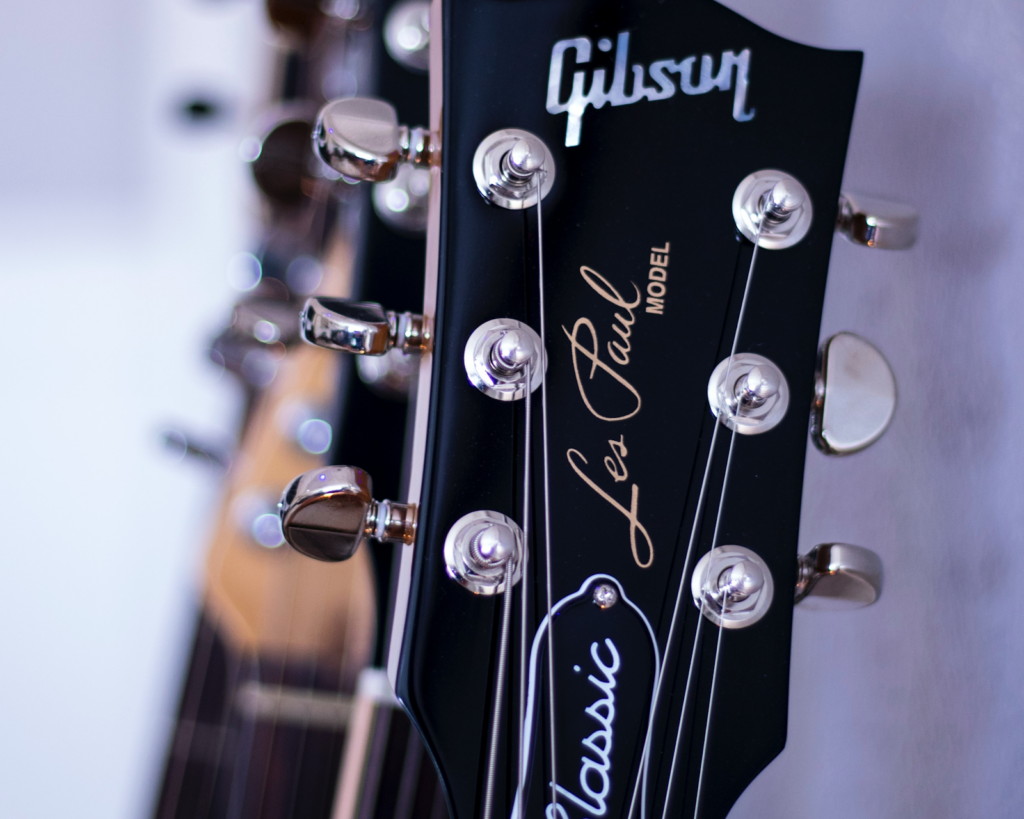 A close-up view of an angled headstock from a Gibson guitar.