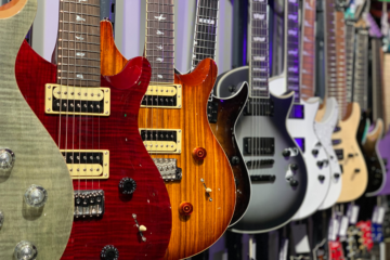 A row of electric guitars hanging on display.