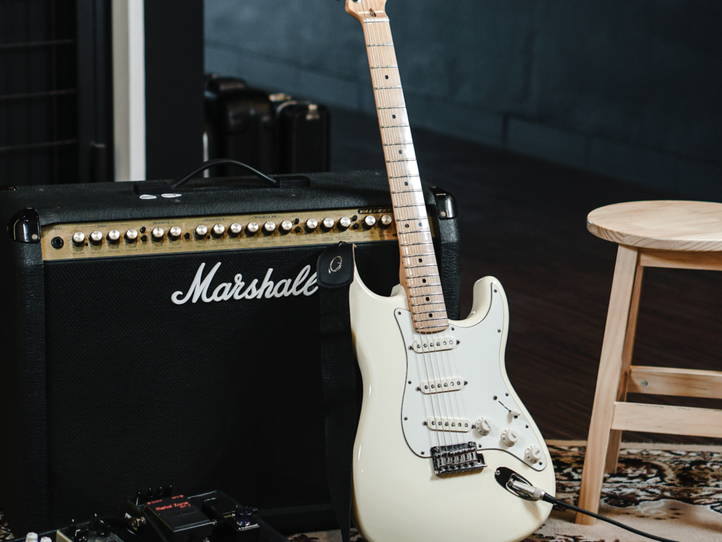 A Marshall amp with a Fender electric guitar.