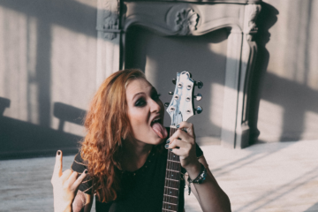 A female rock star posing with her guitar