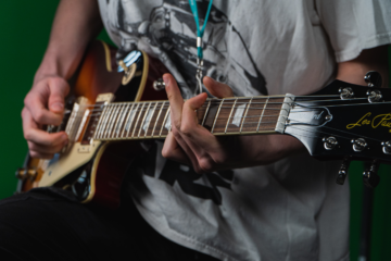 A person playing the electric guitar.