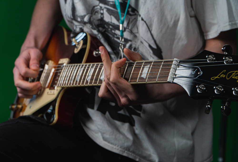 A person playing the electric guitar.
