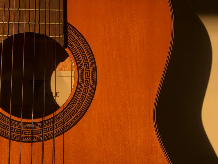 A close up of an acoustic guitar. 