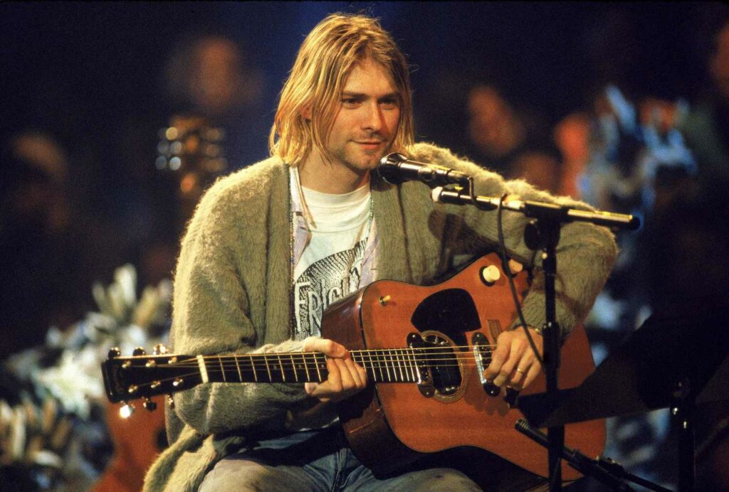 Kurt Cobain from Nirvana performing on stage.