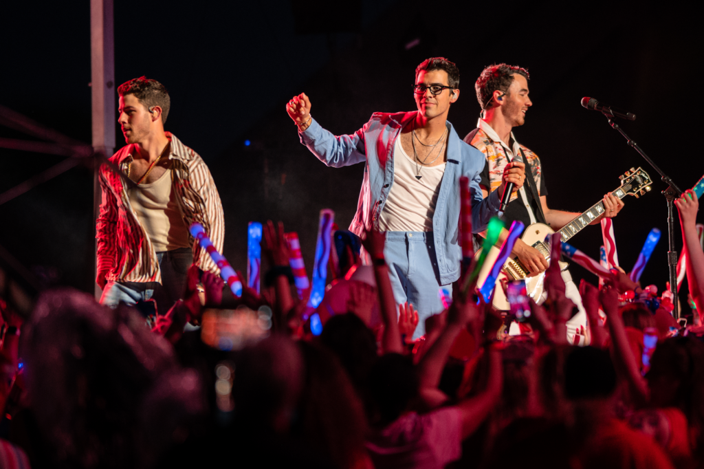 The Jonas Brothers performing on stage.