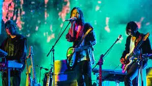 Tame Impala performing on stage.