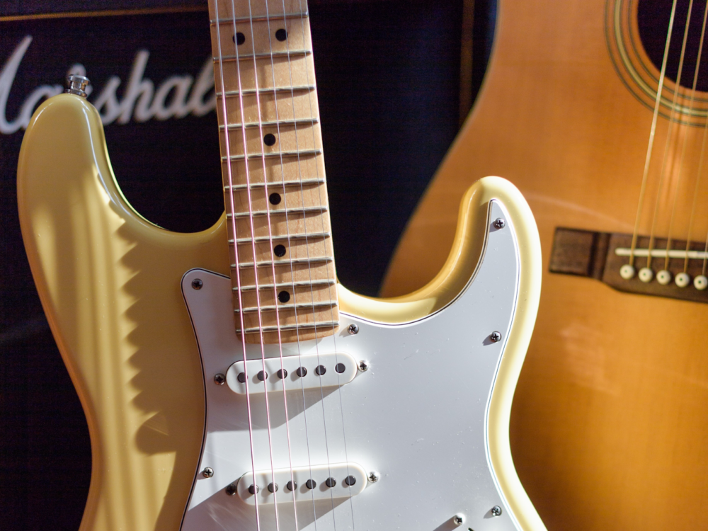 A close up of an electric guitar and a Marshal amp.