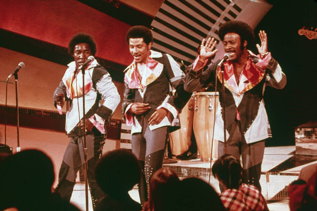 The O' Jays performing on stage.