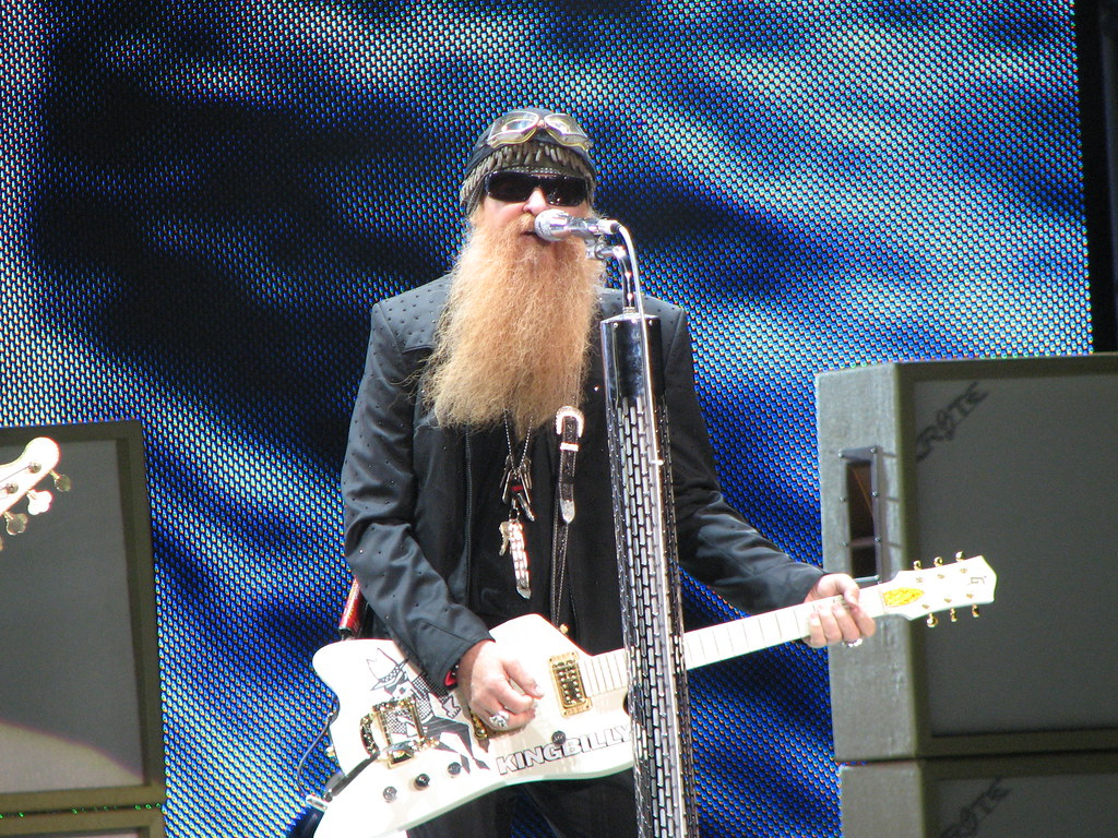 Billy Gibbons performing on stage.
