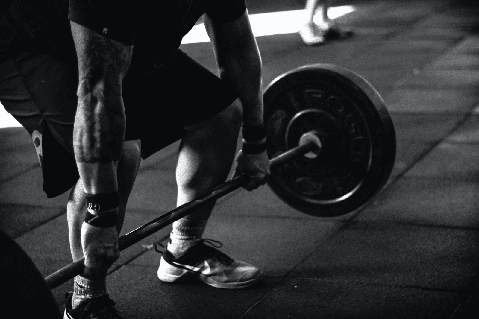 A close up of a man lifting weights.