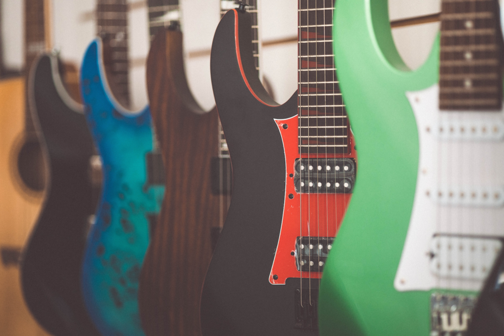 A row of electric guitars on display.