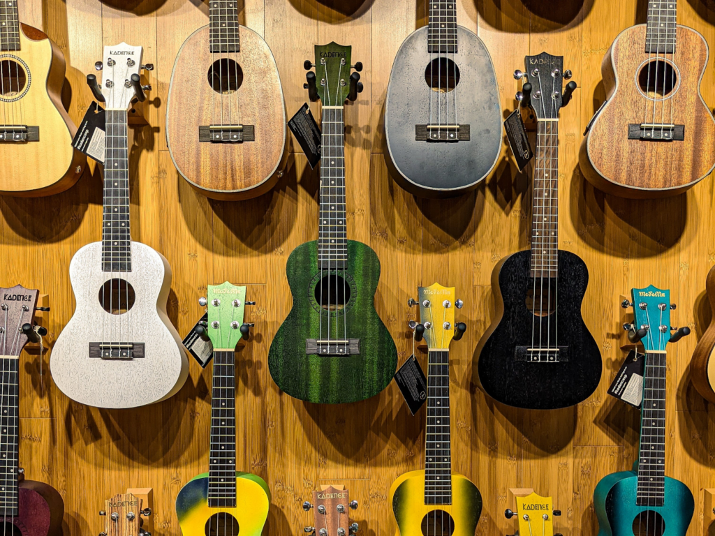 Different types of guitars on display on a wall.