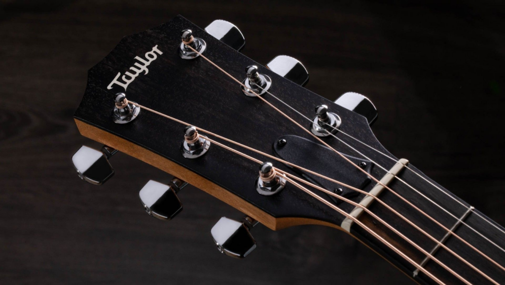 The headstock of a Taylor guitar.