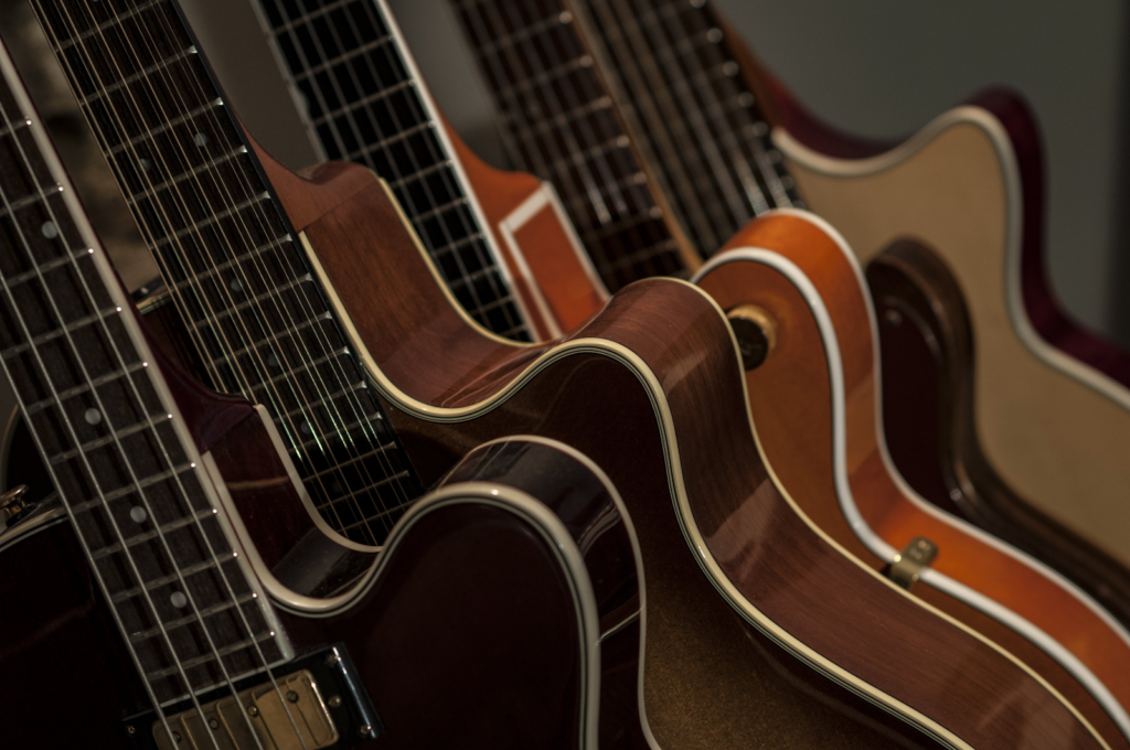 An image of the silhouette of multiple guitars. 