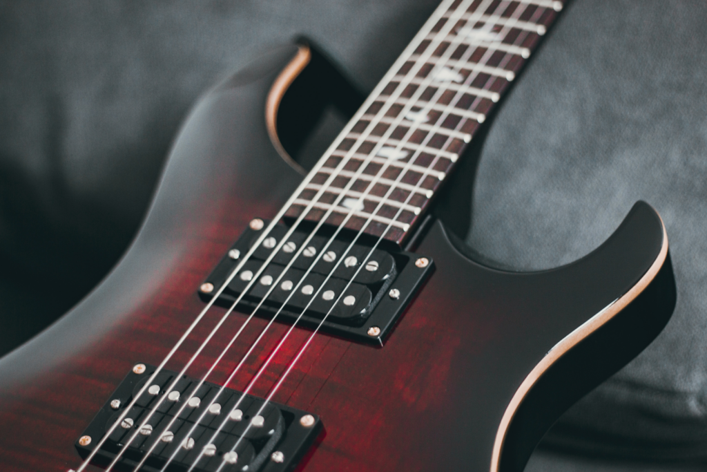 A close up of a six string electric guitar.