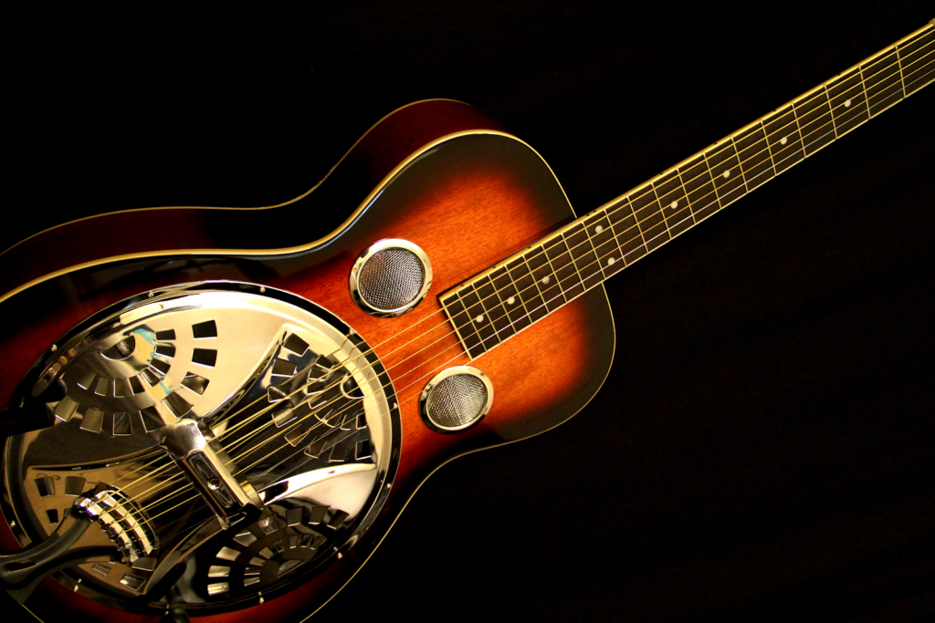 A resonator guitar with ornate soundboard.
