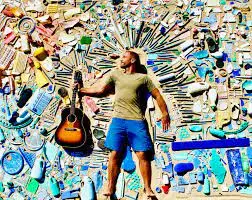 Jack Johnson posing with his guitar for a festival.