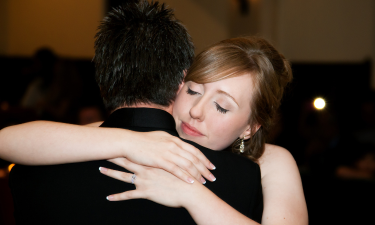 A bride hugging her father.