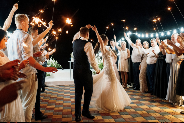 Wedding guests celebrate as the bride and bridegroom have their first dance.